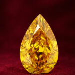 GIA Certified 1.07 CT Pear Diamond Enhanced Orange-Yellow Color (8.35 MM)